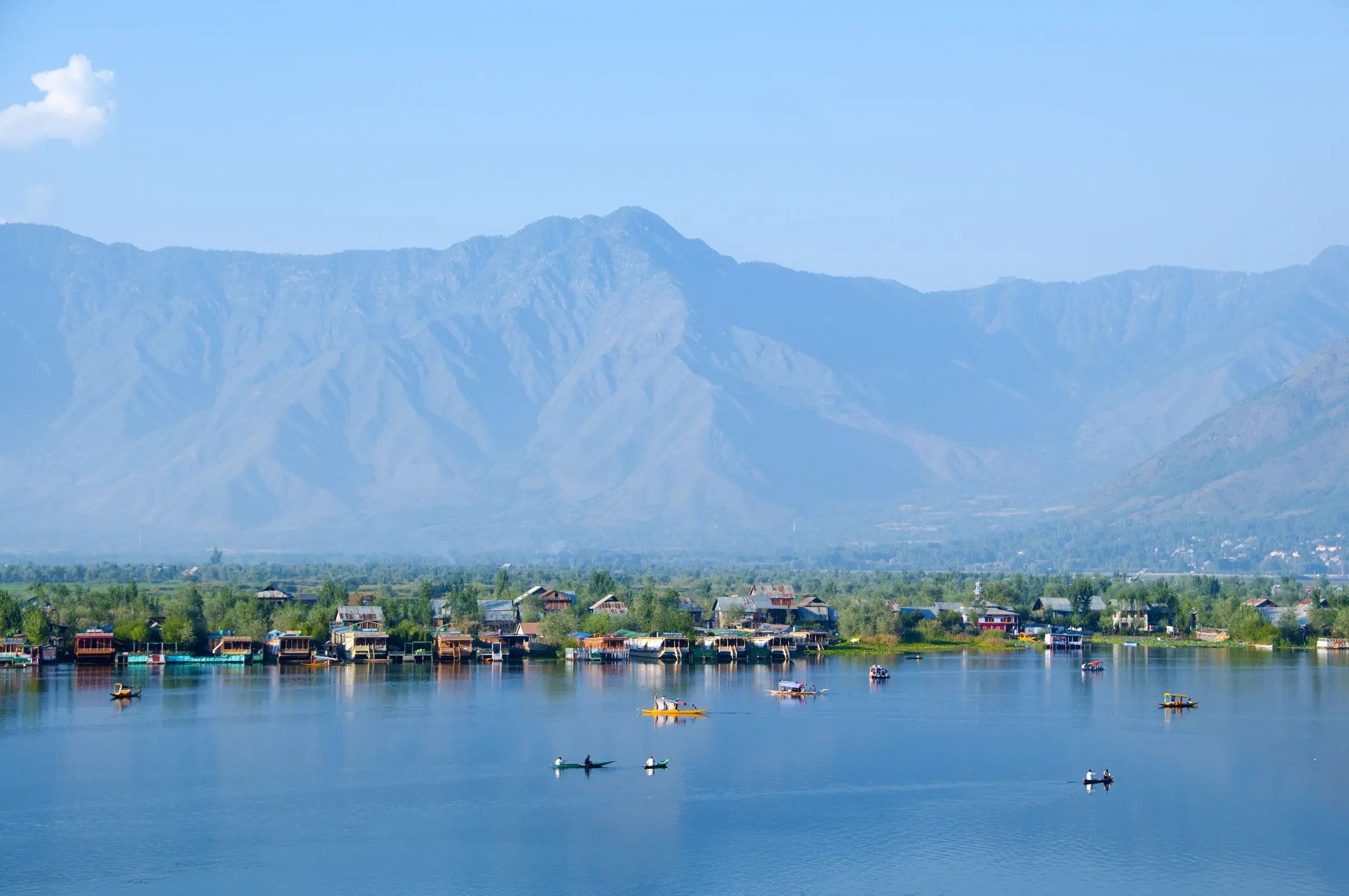 Dal Lake in Srinagar beneath the mountains, with boats on the water