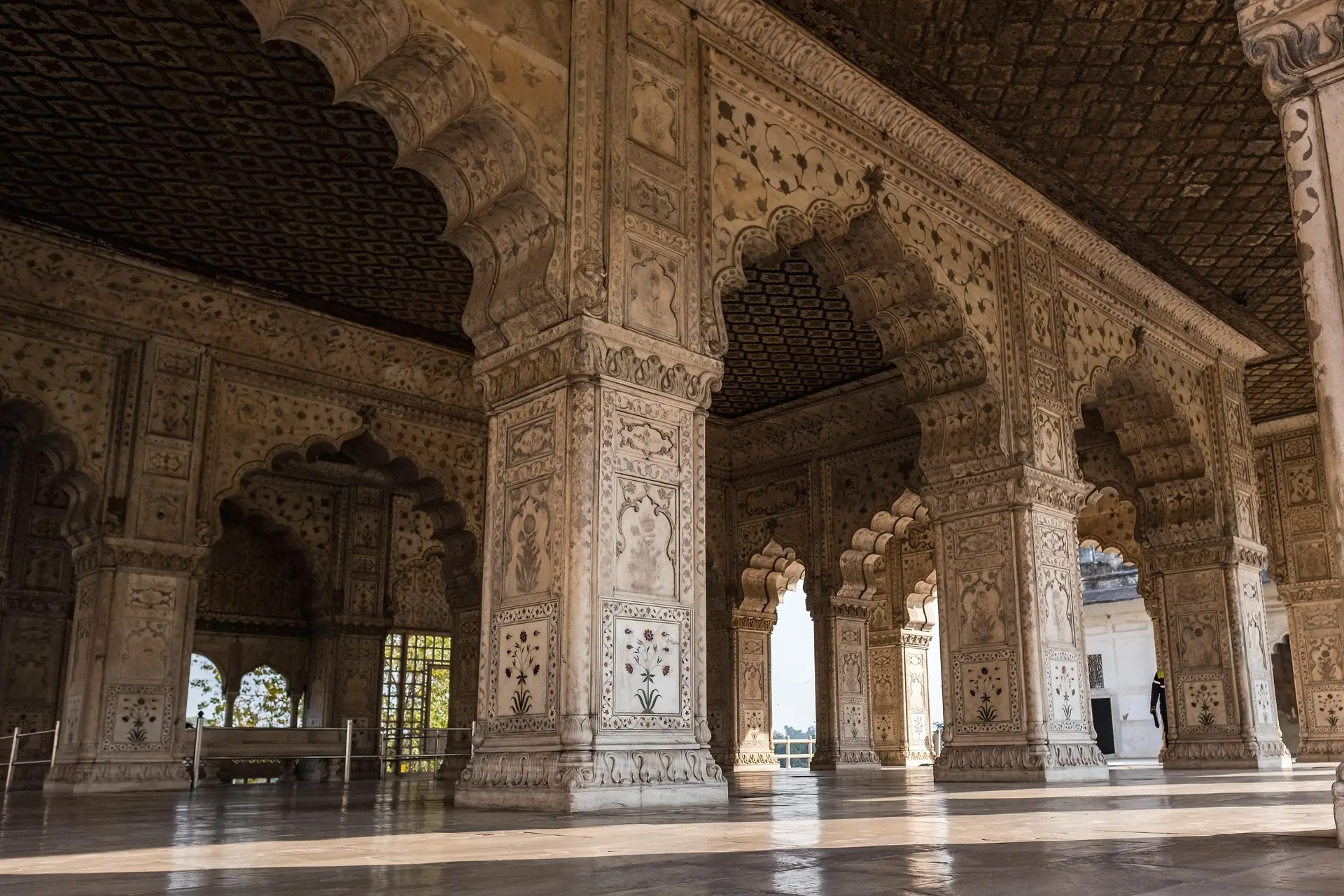 Carved marble arches opening onto daylight in a Mughal pavilion