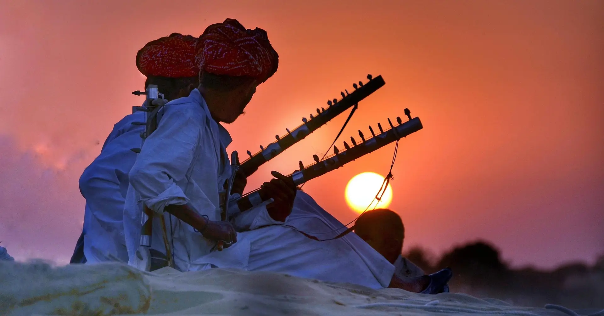 A Rajasthani musician silhouetted against the setting sun